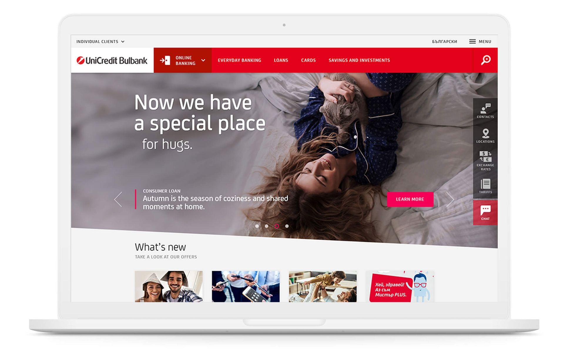 UniCredit Bulbank website homepage screenshot on a laptop, featuring a Consumer Loan banner with a woman cuddling a cat and the headline "Now we have a special place for hugs," alongside the main navigation for Online Banking, Cards, and Savings and Investments.